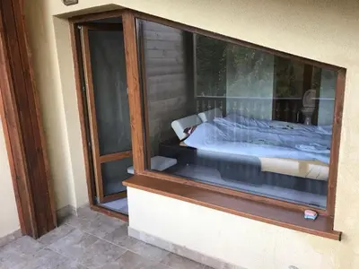 a glass window of a bedroom with a bed in it at Sequoia Loft apartment in Borovets