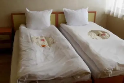two beds with white sheets with dolls on them at Sequoia Loft apartment in Borovets