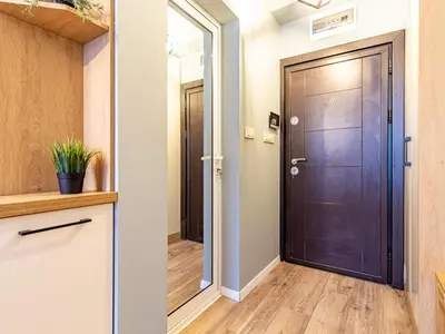 a hallway with a wooden door and a hallway with a hallway at Stay & Explore Sofia - Central Studio in Sofia