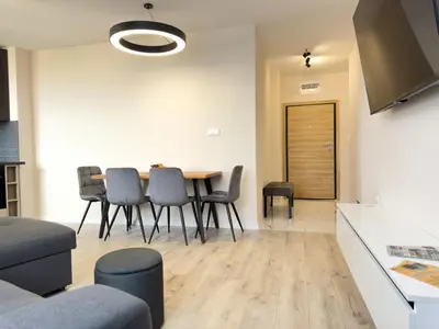 a kitchen and dining room with a table and chairs at 2BR Business Suite with FREE GYM, by Holiwork Stays in Plovdiv