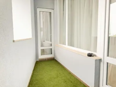 an empty room with a green floor and windows at 2BR Business Suite with FREE GYM, by Holiwork Stays in Plovdiv