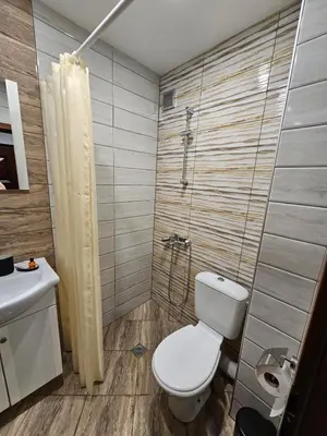 a bathroom with a toilet and a shower and a sink at Studio Secrets in Plovdiv