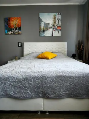 a bedroom with a white bed with a yellow pillow at Studio Secrets in Plovdiv