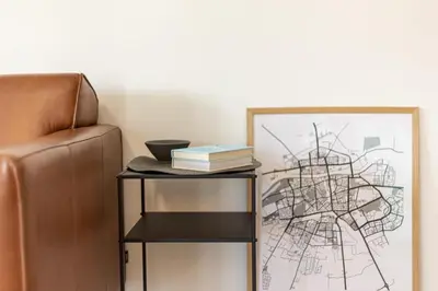 a side table next to a chair and a drawing at Vintage Parkside whit Free Parking near Center in Plovdiv