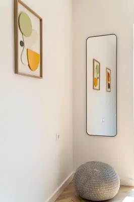 a ottoman sits on the floor in a room with three pictures at Vintage Parkside whit Free Parking near Center in Plovdiv