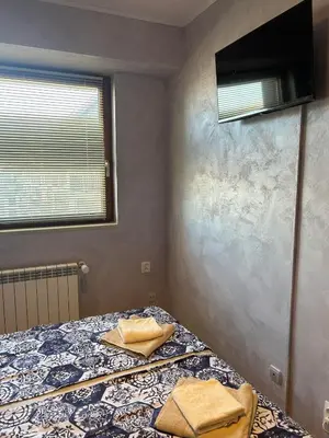 a bedroom with a bed with two towels on it at 1-Bedroom apt - BathTub - 10mins from SkiLift Gondola - freeWiFi - WorkDesk - Central Heating - Full Kitchen at Edelweiss in Bansko