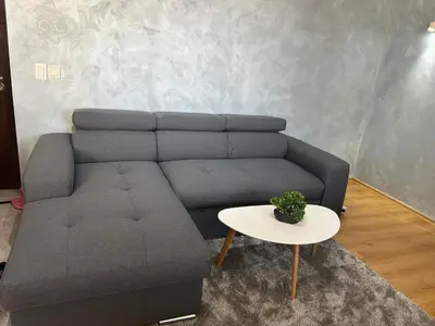 a living room with a couch and a table at 1-Bedroom apt - BathTub - 10mins from SkiLift Gondola - freeWiFi - WorkDesk - Central Heating - Full Kitchen at Edelweiss in Bansko