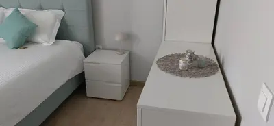 a small bedroom with a bed and a night stand at Apartmenthaus Oborishte - 17 in Panagyurishte