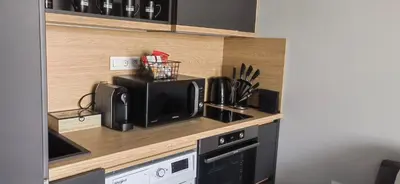 a kitchen with a microwave and a coffee maker on a counter at Apartmenthaus Oborishte - 17 in Panagyurishte