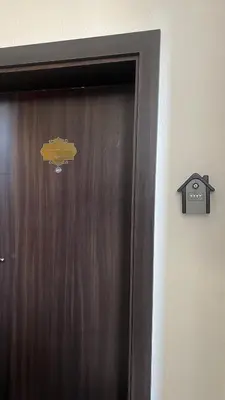 a wooden door with a fish sign on it at Апартамен за гости Панови in Plovdiv