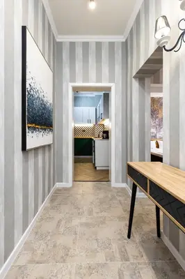 a dining room with a table and a painting on the wall at The Urban Nest-2BD Apartment with a Terrace by Flat Mаnager in Plovdiv