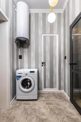 a washer and dryer in a room with a door at The Urban Nest-2BD Apartment with a Terrace by Flat Mаnager in Plovdiv
