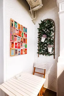 a white room with a bench and a picture on the wall at The Urban Nest-2BD Apartment with a Terrace by Flat Mаnager in Plovdiv