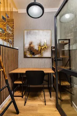 a table and chairs in a room with a painting at The Urban Nest-2BD Apartment with a Terrace by Flat Mаnager in Plovdiv
