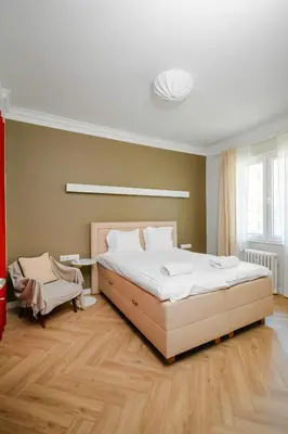 a bedroom with a large white bed and a window at Stylish 1BD Apartment in the Heart of the City by Flat Mаnager in Sofia
