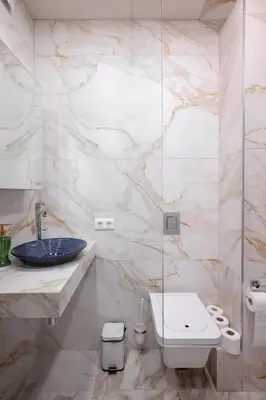 a white bathroom with a sink and a toilet at Stylish 1BD Apartment in the Heart of the City by Flat Mаnager in Sofia