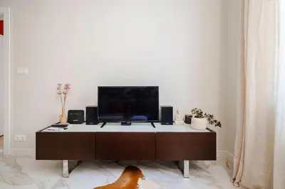 a living room with a tv on top of a cabinet at Stylish 1BD Apartment in the Heart of the City by Flat Mаnager in Sofia