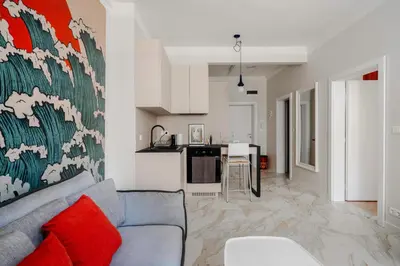 a living room with a couch and a kitchen at Stylish 1BD Apartment in the Heart of the City by Flat Mаnager in Sofia