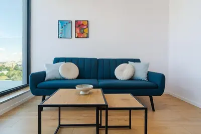a blue couch in a living room with a coffee table at My Campus 1 bdrm, Romantic, Panorama view, Free parking, Self check-in in Sofia
