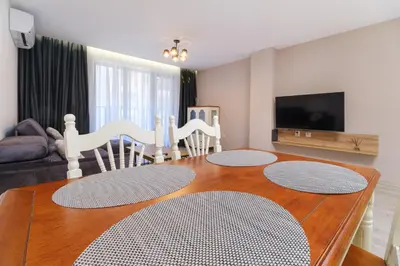 a living room with a wooden table and a dining room at LDV 13 1-Bedroom Apartments Free private parking in Plovdiv