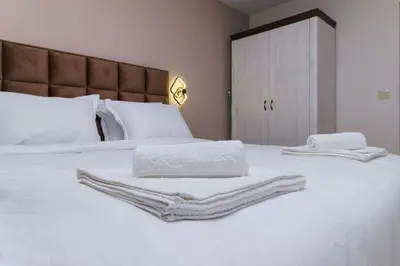 a bedroom with two beds with white towels on them at LDV 13 1-Bedroom Apartments Free private parking in Plovdiv