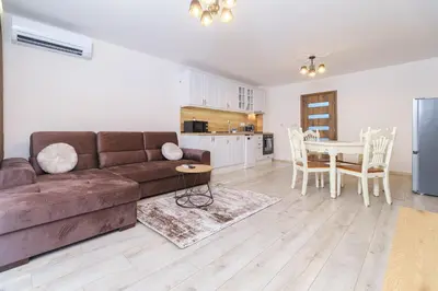 a living room with a brown couch and a table at LDV 13 1-Bedroom Apartments Free private parking in Plovdiv