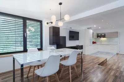 a dining room with a glass table and white chairs at Spacious and modern apt, 6 guests, Central station, self check-in in Sofia