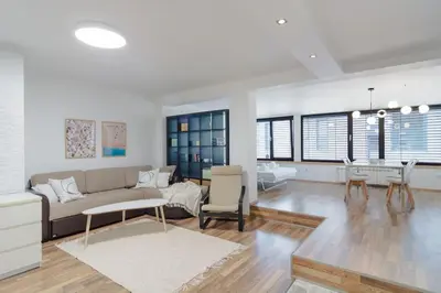 a living room with a couch and a table at Spacious and modern apt, 6 guests, Central station, self check-in in Sofia