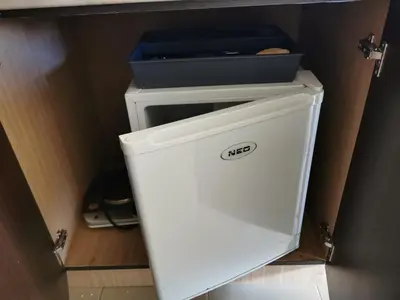 a white refrigerator with a box on top of it at ICEBERG Ski Apartment No19 in Pamporovo