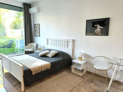 a bedroom with a bed and a table and chairs at My Campus Studios, free parking, self-check in in Sofia