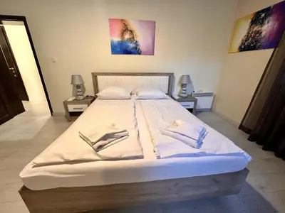 a large bed with white sheets and pillows at Prime Stays at 34 Bratya Miladinovi Street in Sofia