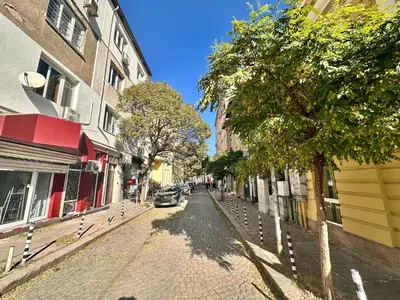 a cobblestone street in a city with buildings at Prime Stays at 34 Bratya Miladinovi Street in Sofia