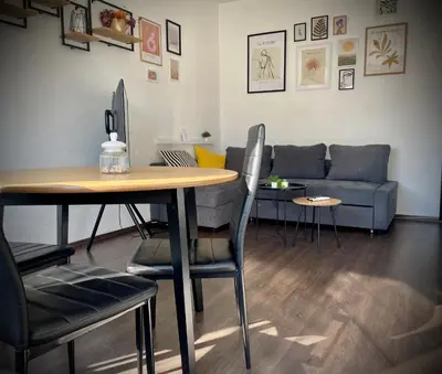 a living room with a table and a couch at Cozy APT Free Parking Wi-Fi Netflix in Sofia