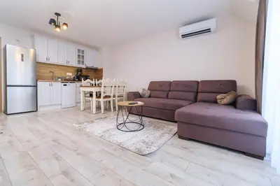 a living room with a couch and a kitchen at LDV 13 Apartments Free private parking in Plovdiv
