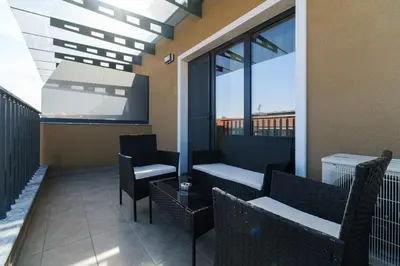 a balcony with chairs and tables on a building at LDV 13 Apartments Free private parking in Plovdiv