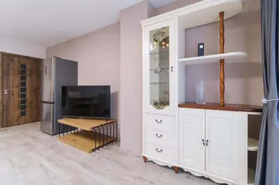 a kitchen with a large white cabinet and a refrigerator at LDV 13 Apartments Free private parking in Plovdiv