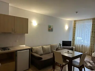 a living room with a couch and a table at Stream Spa Suite in Pamporovo