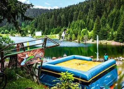a large blue inflatable bed in front of a lake at Stream Spa Suite in Pamporovo