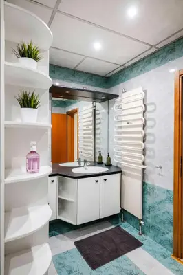 a bathroom with white cabinets and a sink at Charming 2BD Apartment in the Heart of the City by Flat Mаnager in Sofia
