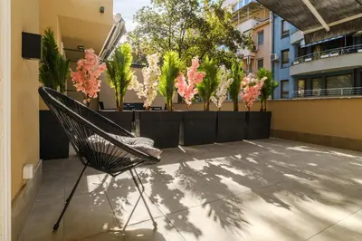 a hammock on a balcony with pink flowers at LDV 13 Residence Free private parking in Plovdiv