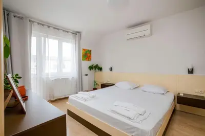 a white room with a bed and a window at Spacious 2BD Flat with Secure Free Parking by Flat Mаnager in Sofia