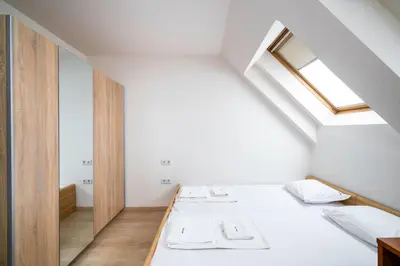 two beds in a room with a skylight at Spacious 2BD Flat with Secure Free Parking by Flat Mаnager in Sofia