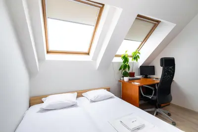 a bedroom with a bed and a desk with a computer at Spacious 2BD Flat with Secure Free Parking by Flat Mаnager in Sofia
