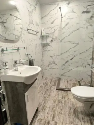 a bathroom with a sink and a toilet at Snow White - Luxury Stay with free Bottle of Wine in Bansko