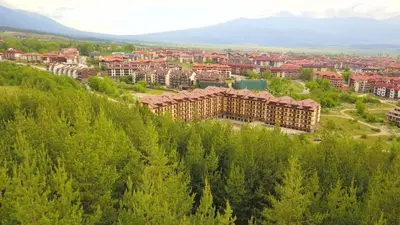 an aerial view of a building in the trees at Snow White - Luxury Stay with free Bottle of Wine in Bansko