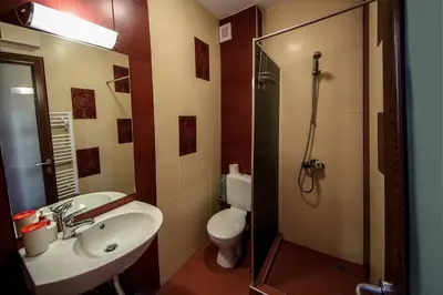 a bathroom with a toilet and a sink and a shower at Guest House Vessyta in Sapareva Banya