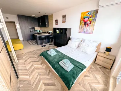 a bedroom with a bed with towels on it at Best View Studio in Sofia
