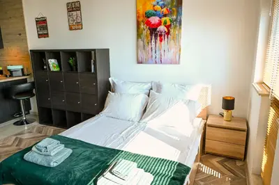a bedroom with a bed and a painting on the wall at Best View Studio in Sofia