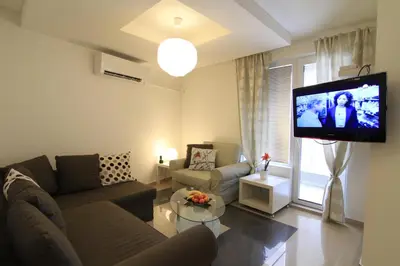 a living room with a couch and a flat screen tv at Stay Nexus Galaxy Center in Sofia