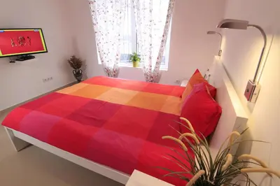 a bedroom with a bed with a colorful blanket at Stay Nexus Galaxy Center in Sofia